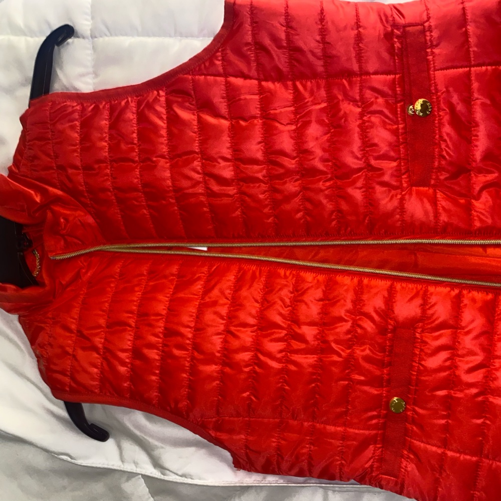 Red lightly padded vest with gold hardware